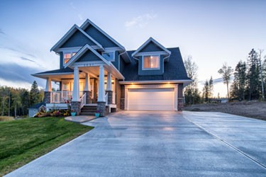 grey and blue house illuminated at dusk